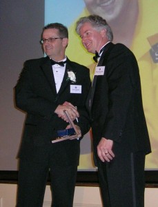 Jean Theoret accepts award