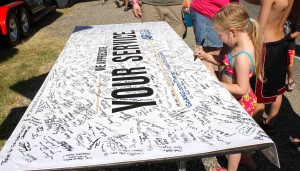 A fan signs a banner Saturday.